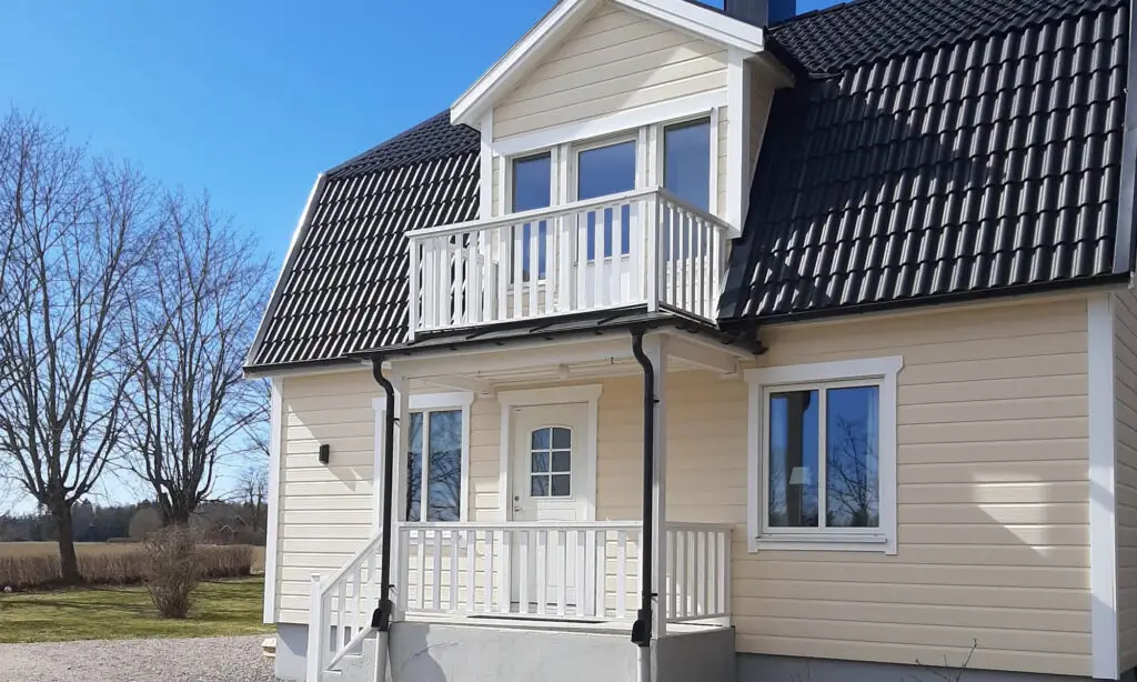 Sandfärgad Västkustpanel på snyggt hus